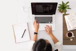 woman typing on laptop